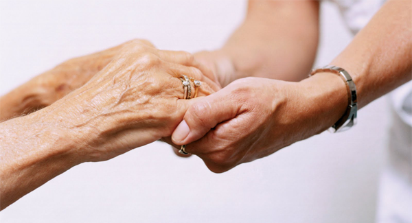 elderly hands with younger hands